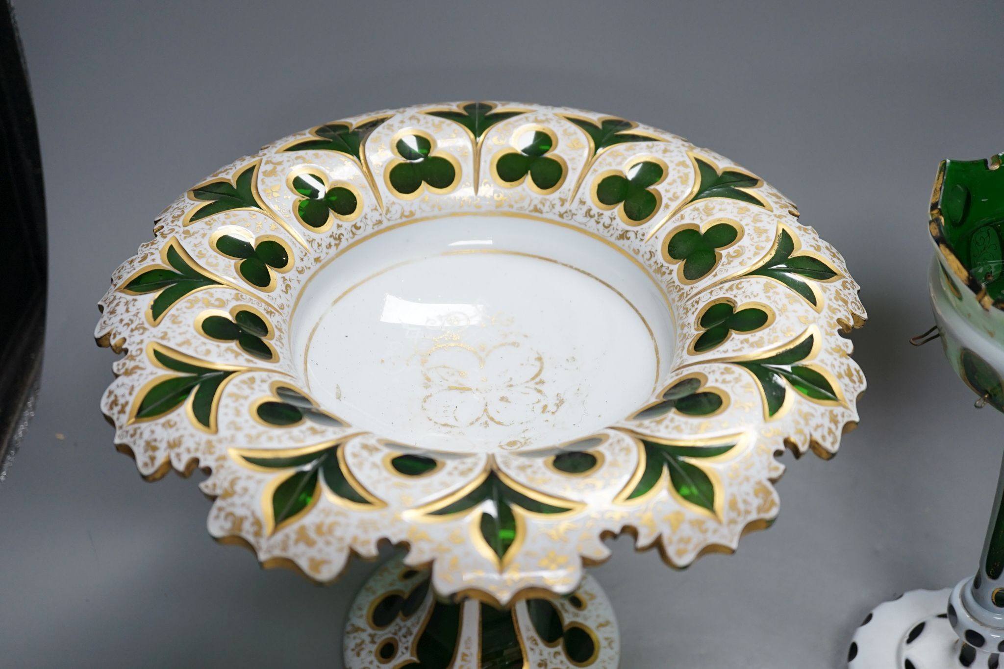 A 19th century overlaid green glass comport, 24cm high, and a similar table lustre